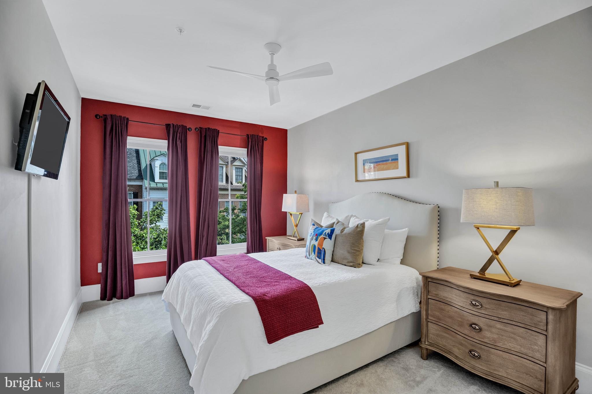 708 Day Lane Alexandria, VA 22314 - Photo 19 of 39 a bedroom with a large bed and a flat tv screen on dresser