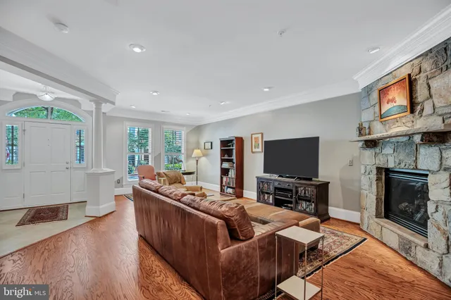 a living room with fireplace furniture and a flat screen tv