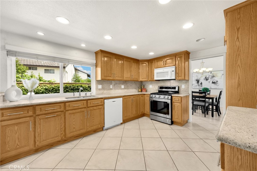 1342 Beechwood Drive Brea, CA 92821 - Photo 13 of 43 a large kitchen with stainless steel appliances granite countertop a stove a sink and a microwave