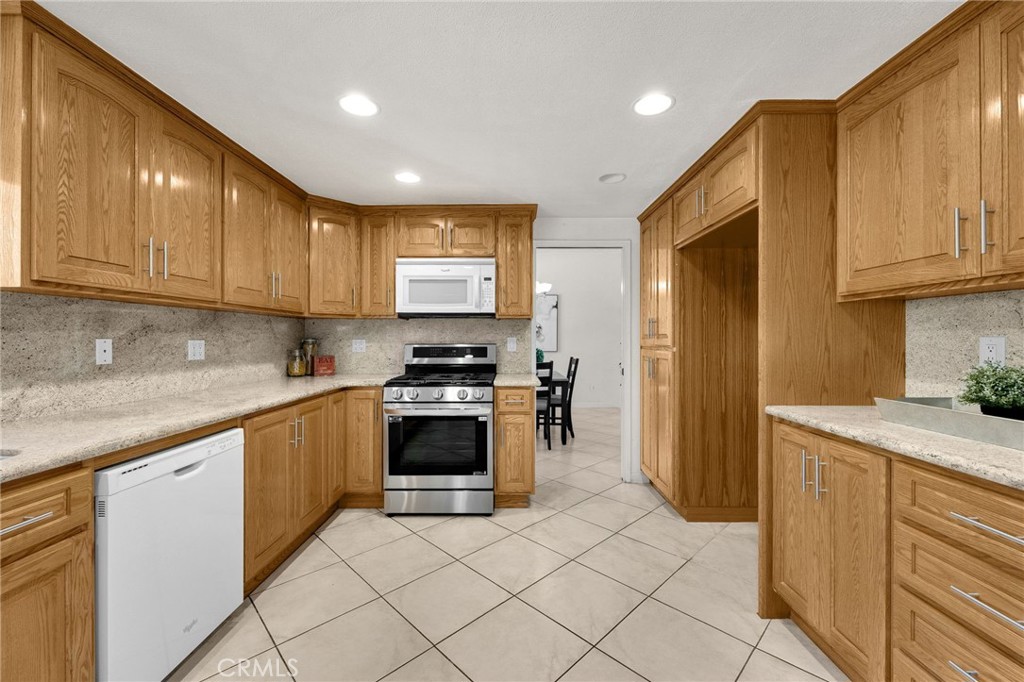 1342 Beechwood Drive Brea, CA 92821 - Photo 16 of 43 a kitchen with stainless steel appliances granite countertop a refrigerator sink and cabinets