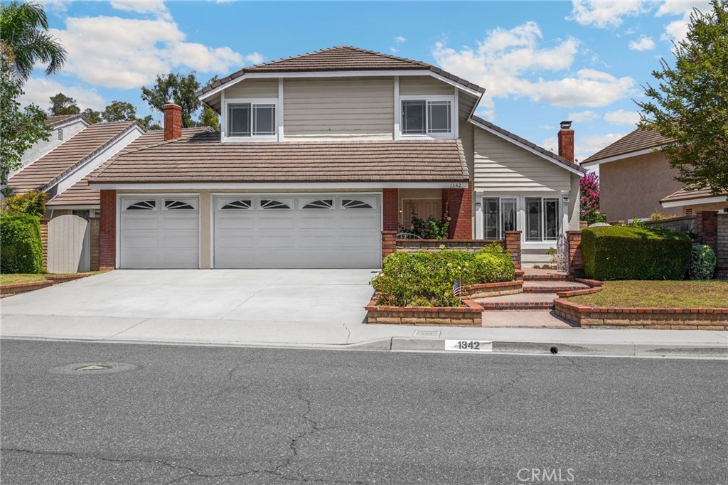 1342 Beechwood Drive Brea, CA 92821 - Photo 2 of 43 a front view of a house with a yard and garage