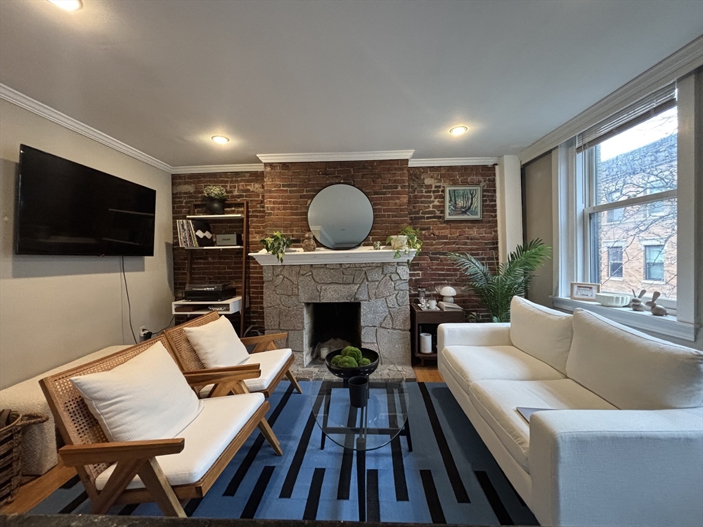 41 Grove Boston Ma, Unit 4 Boston, MA 02114 - Photo 1 of 20 a living room with furniture a flat screen tv and a fireplace