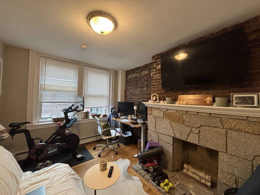 41 Grove Boston Ma, Unit 4 Boston, MA 02114 - Photo 11 of 20 a room with furniture a window and gym equipment