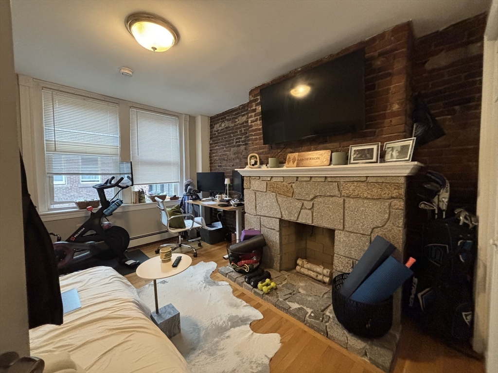 41 Grove Boston Ma, Unit 4 Boston, MA 02114 - Photo 14 of 20 a living room with furniture a fireplace and kitchen view