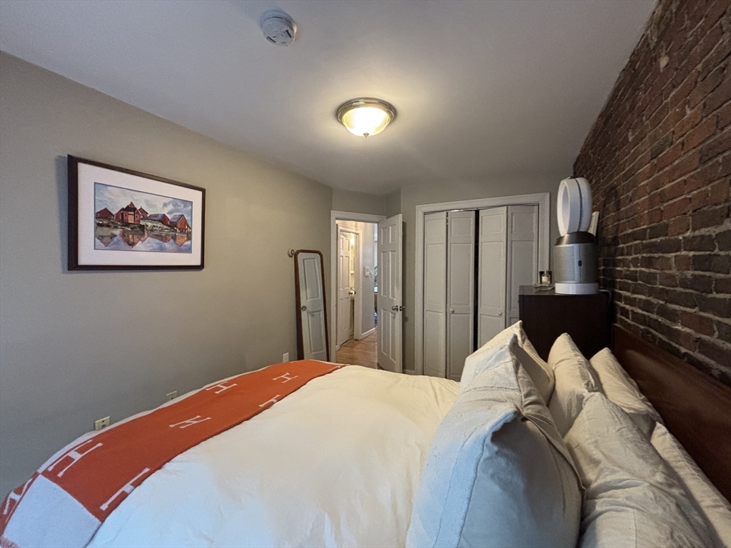41 Grove Boston Ma, Unit 4 Boston, MA 02114 - Photo 16 of 20 a bedroom with bed and wall painting