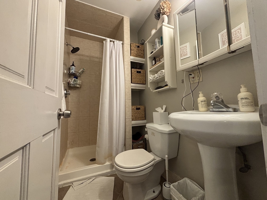 41 Grove Boston Ma, Unit 4 Boston, MA 02114 - Photo 19 of 20 a bathroom with a sink toilet and shower