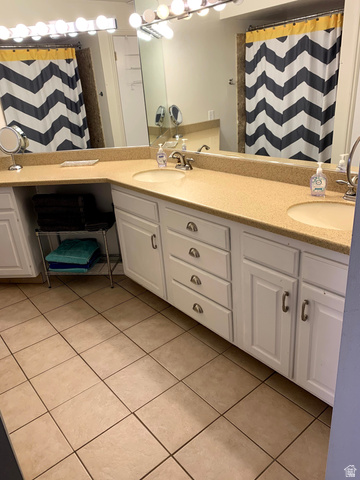 860 South Village Road, Unit B11 St. George, UT 84770 - Photo 14 of 19 Bathroom featuring double vanity, a shower with curtain, and light tile patterned floors