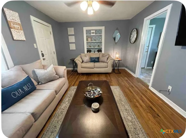 a living room with furniture and a fireplace