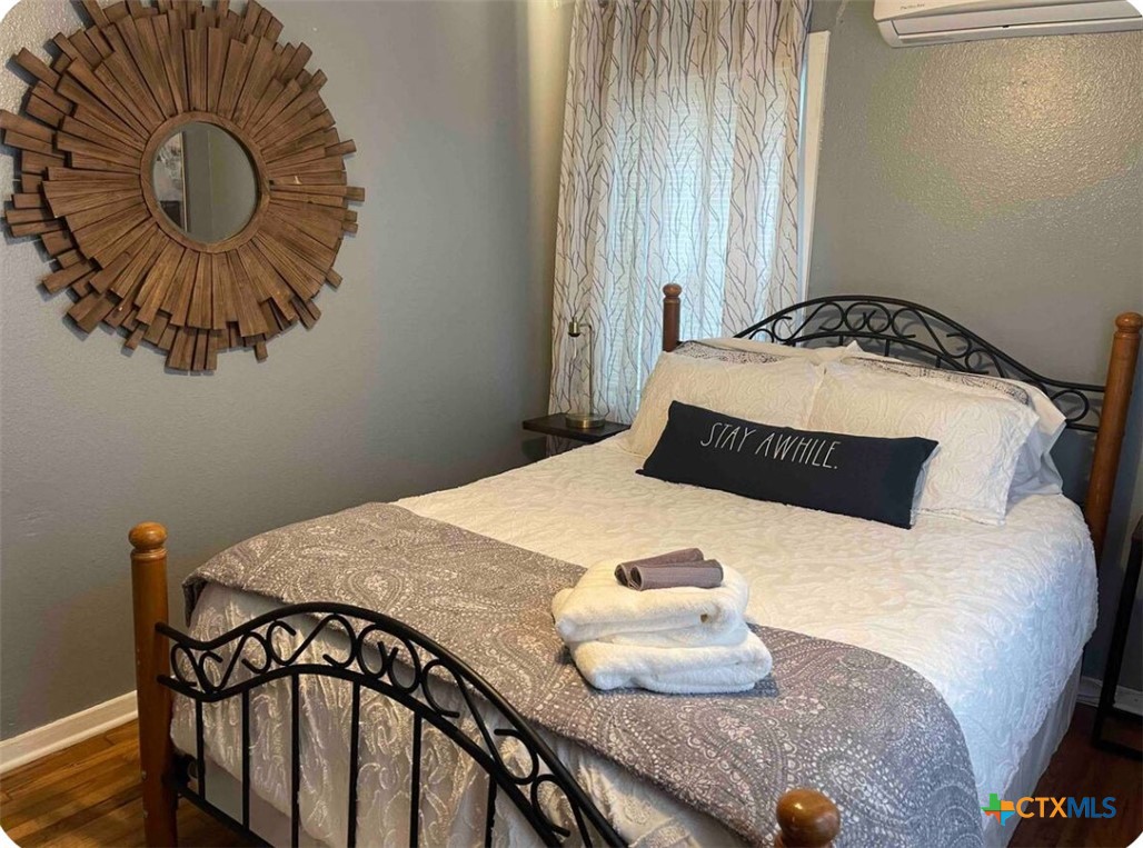 284 Perryman Street New Braunfels, TX 78130 - Photo 14 of 41 a bedroom with a bed and a chandelier