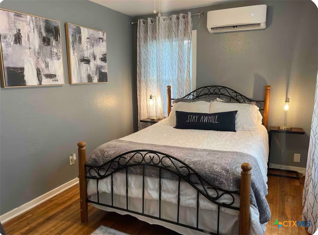 284 Perryman Street New Braunfels, TX 78130 - Photo 15 of 41 a bedroom with a bed and wooden floor