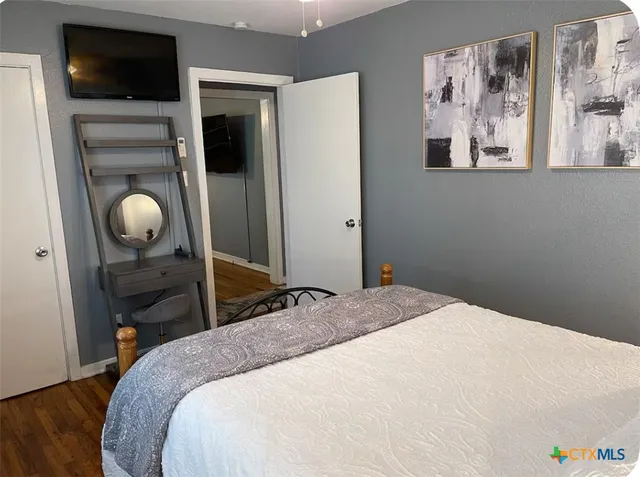 a bedroom with a bed and cabinets
