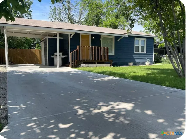 a view of house with backyard space and garden