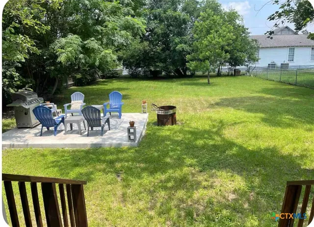 a view of a two chairs in the patio