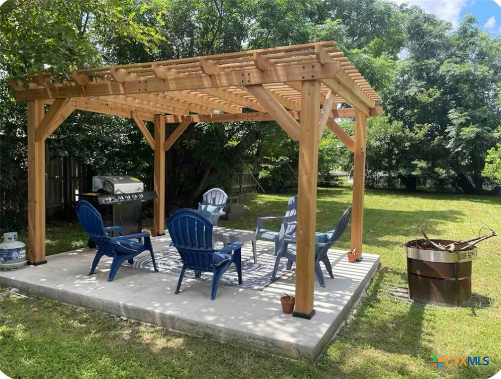 284 Perryman Street New Braunfels, TX 78130 - Photo 36 of 41 a view of a patio with a table chairs and a backyard