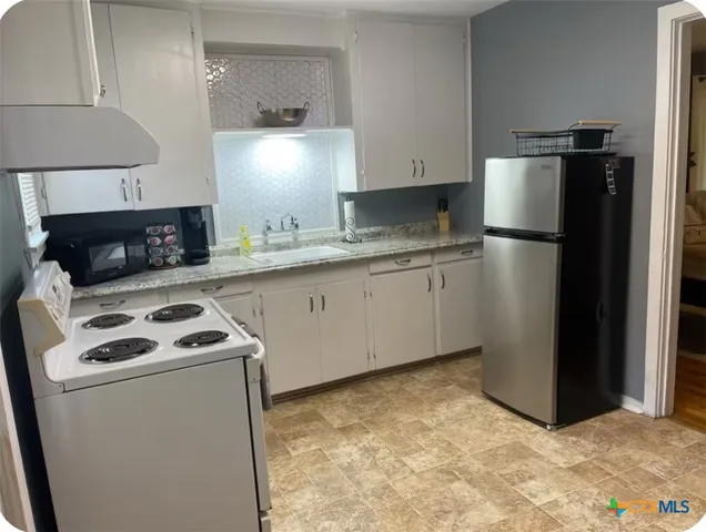 a kitchen with a sink a stove and refrigerator