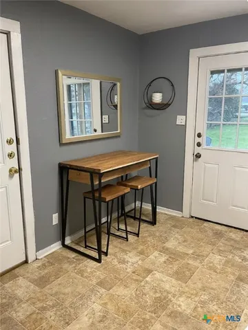 a view of workspace with furniture and window