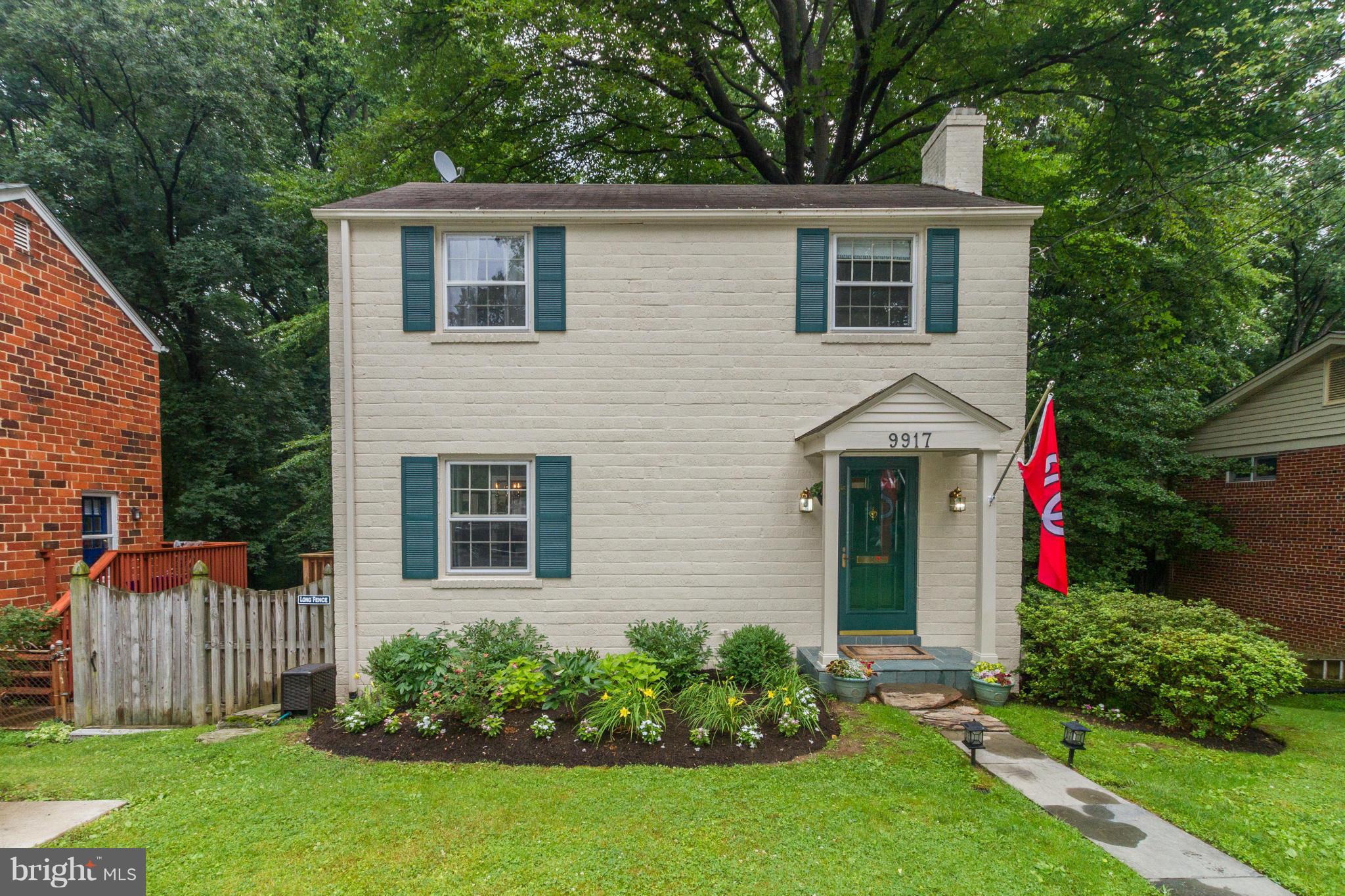 9917 Big Rock Road Silver Spring, MD 20901 - Photo 1 of 24 a front view of a house with a yard and trees