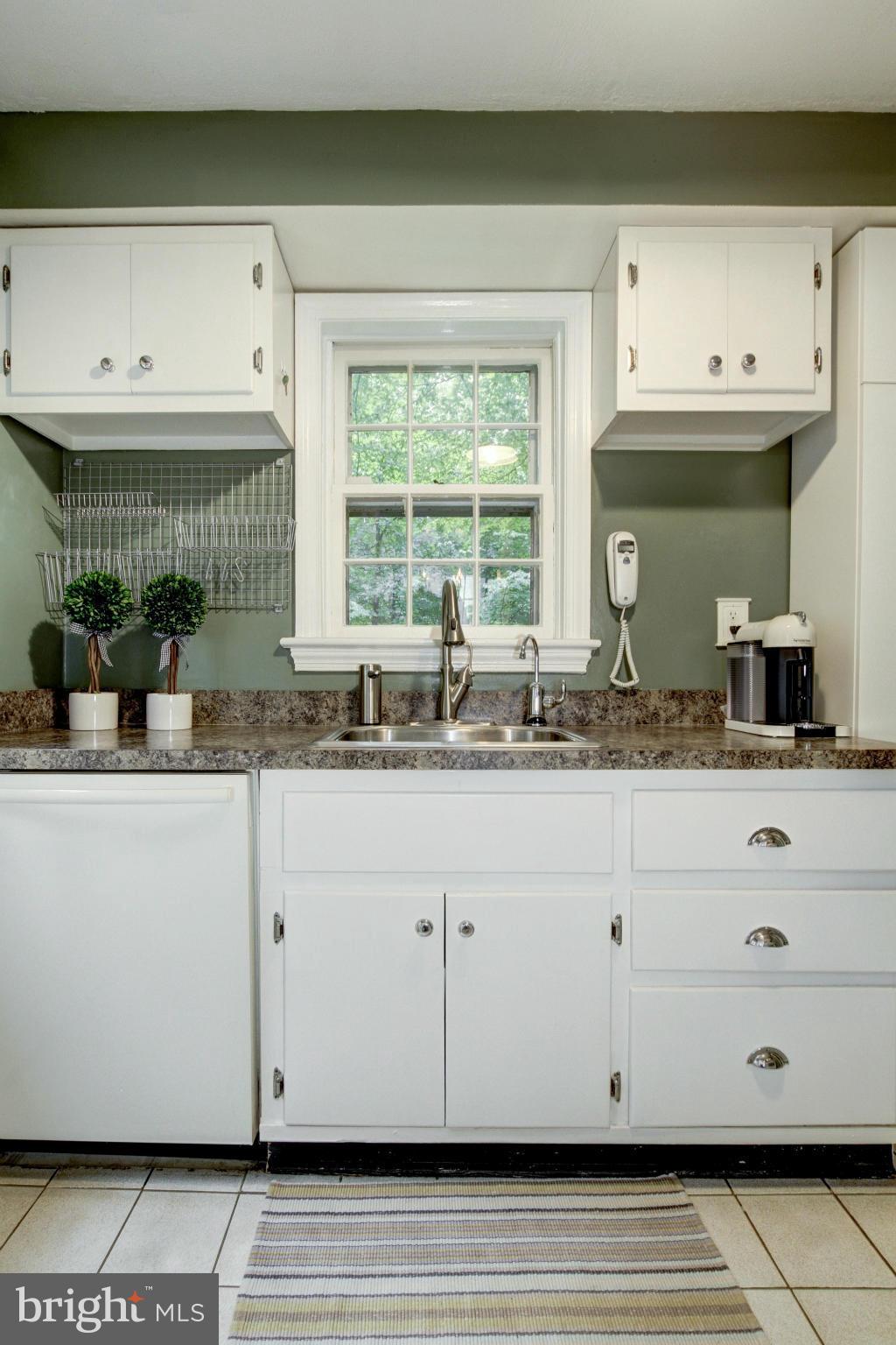 9917 Big Rock Road Silver Spring, MD 20901 - Photo 11 of 24 a kitchen with granite countertop white cabinets and a window