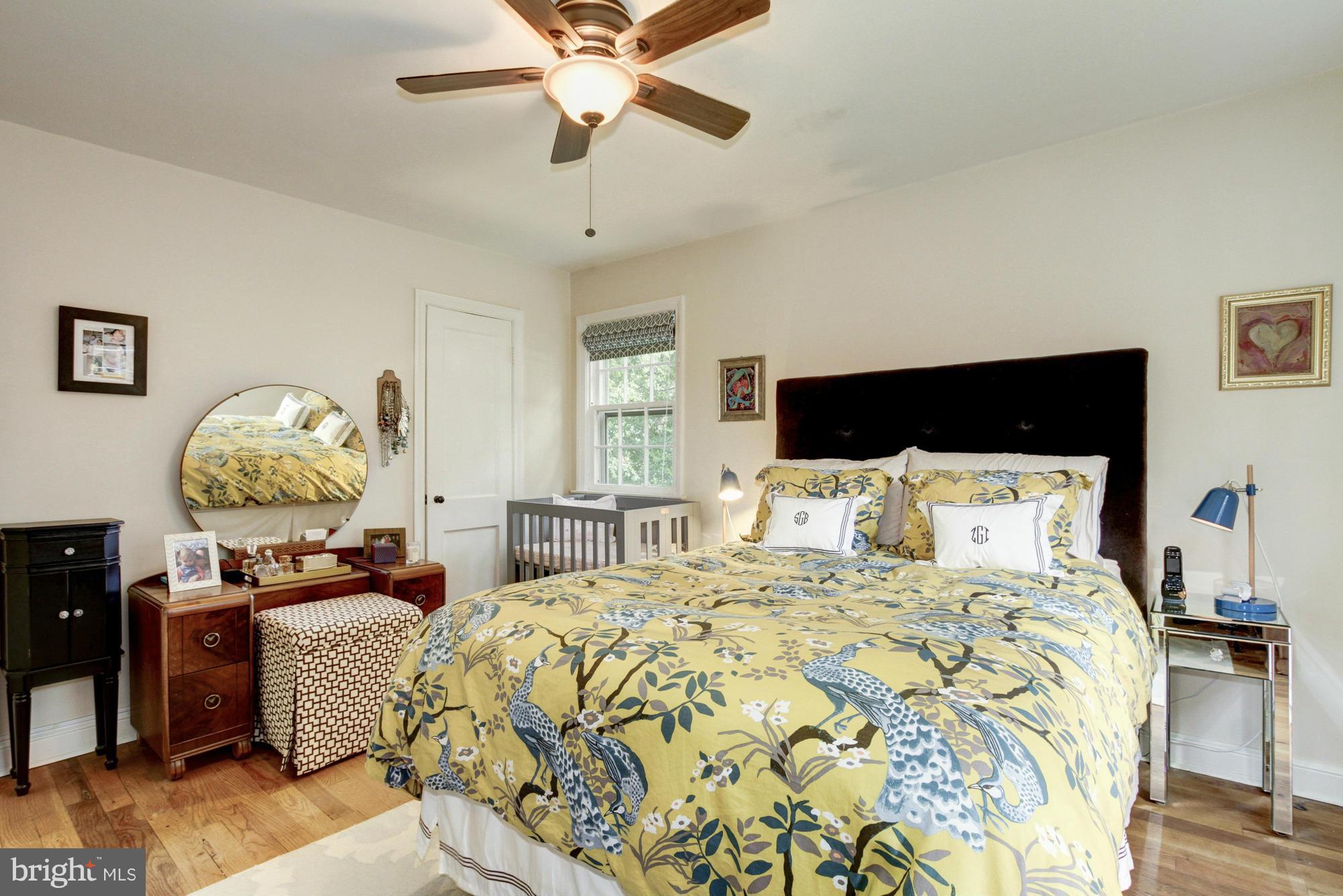 9917 Big Rock Road Silver Spring, MD 20901 - Photo 13 of 24 a bedroom with a bed and a chandelier