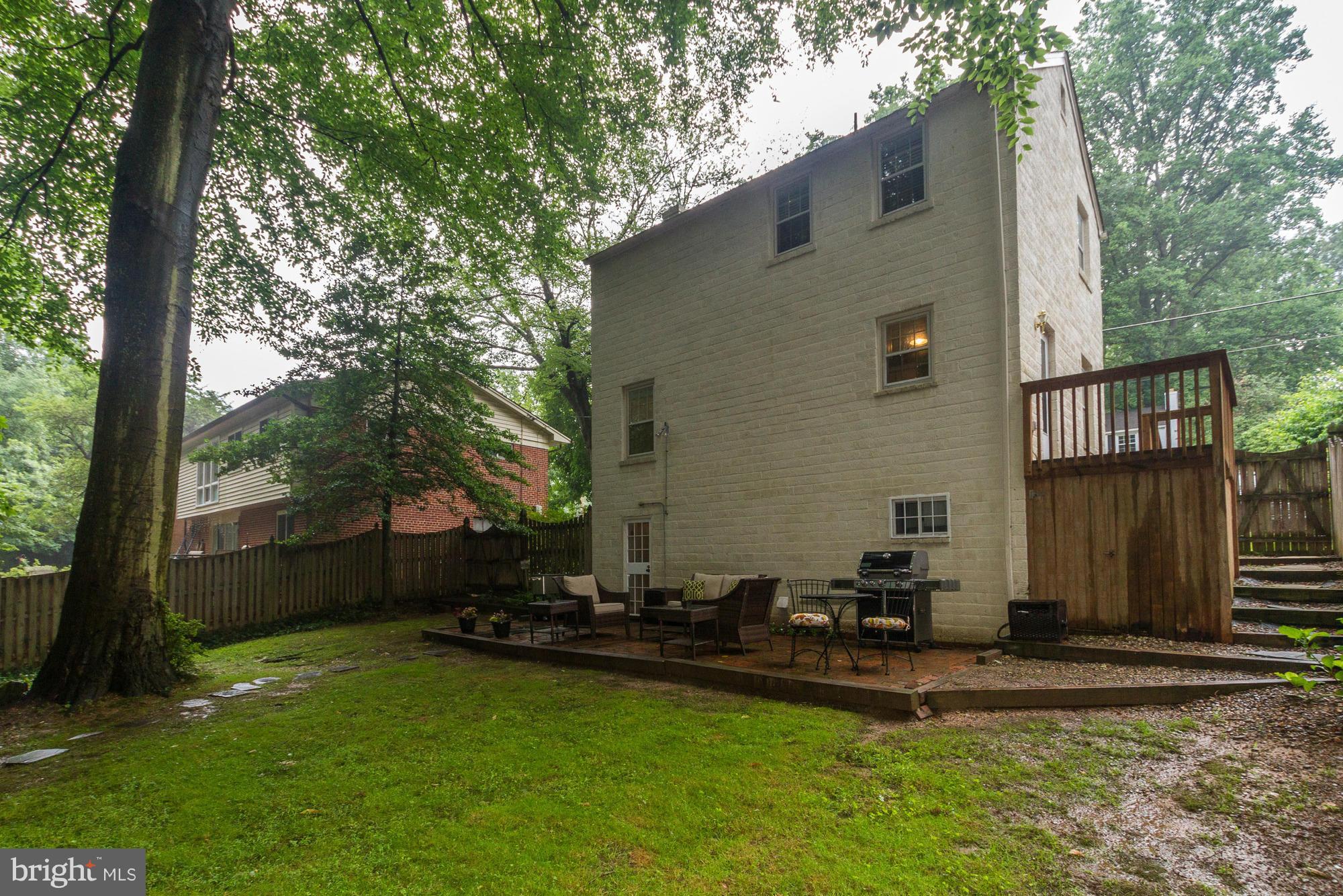 9917 Big Rock Road Silver Spring, MD 20901 - Photo 23 of 24 a backyard of a house with table and chairs