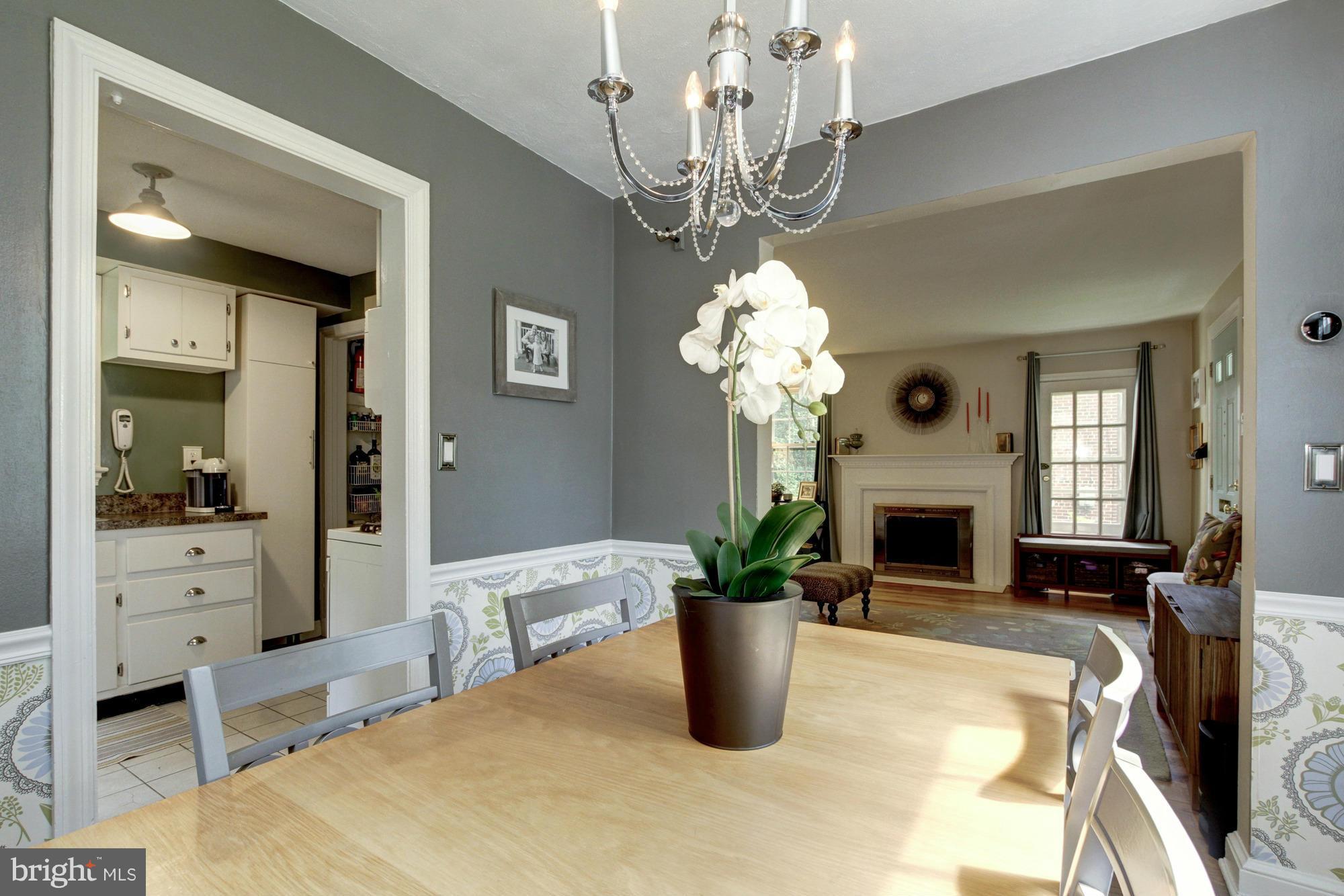 9917 Big Rock Road Silver Spring, MD 20901 - Photo 8 of 24 a dining room with fireplace chandelier