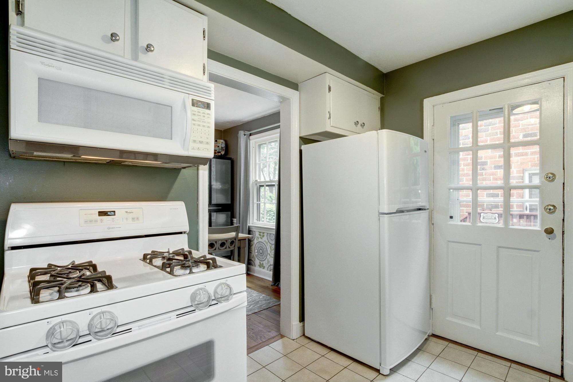 9917 Big Rock Road Silver Spring, MD 20901 - Photo 10 of 24 a kitchen with a stove and a refrigerator