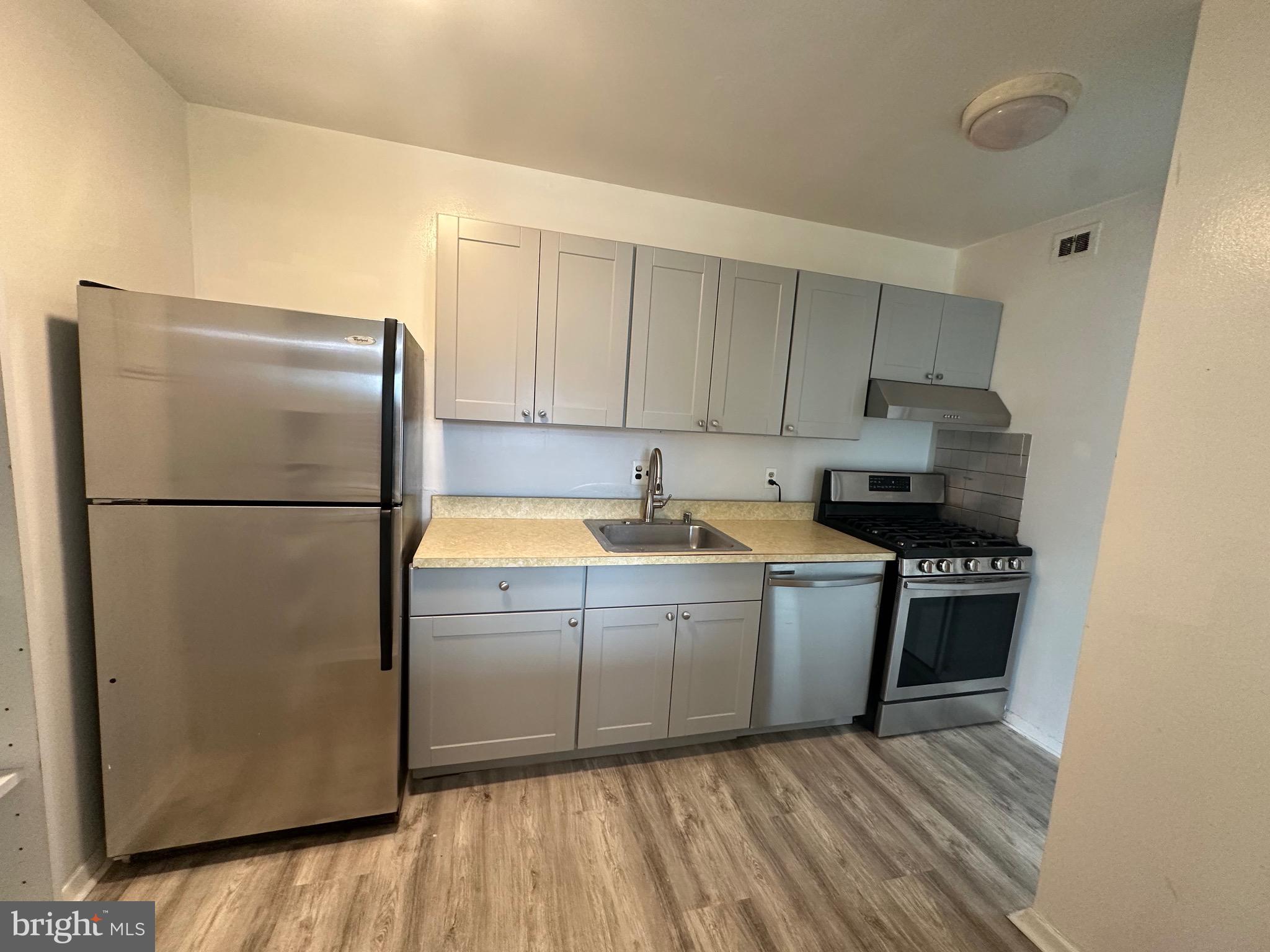 3722 Bel Pre Road, Unit 12 Silver Spring, MD 20906 - Photo 11 of 26 a kitchen with stainless steel appliances granite countertop a refrigerator and a stove