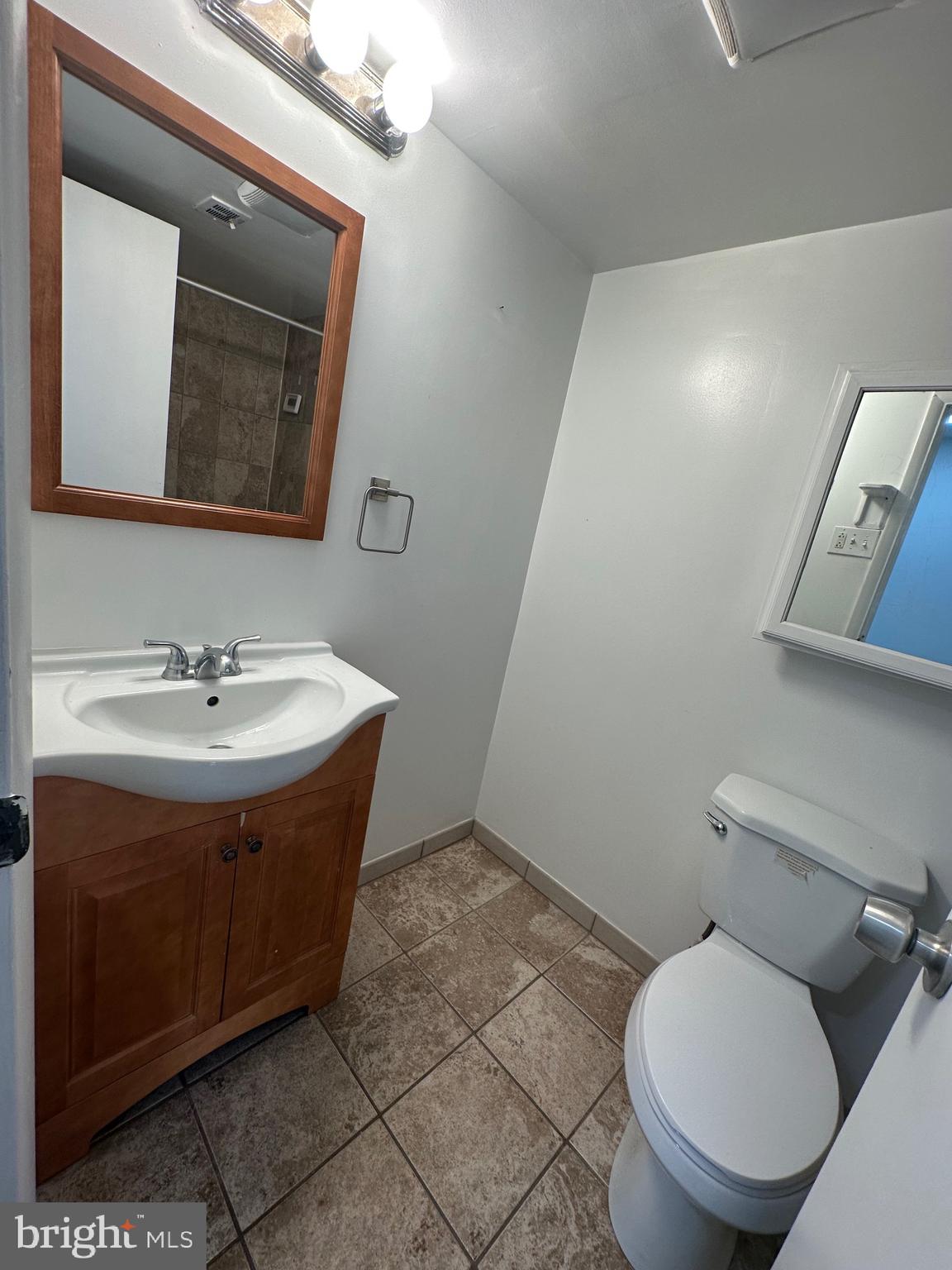 3722 Bel Pre Road, Unit 12 Silver Spring, MD 20906 - Photo 17 of 26 a bathroom with a toilet sink and mirror