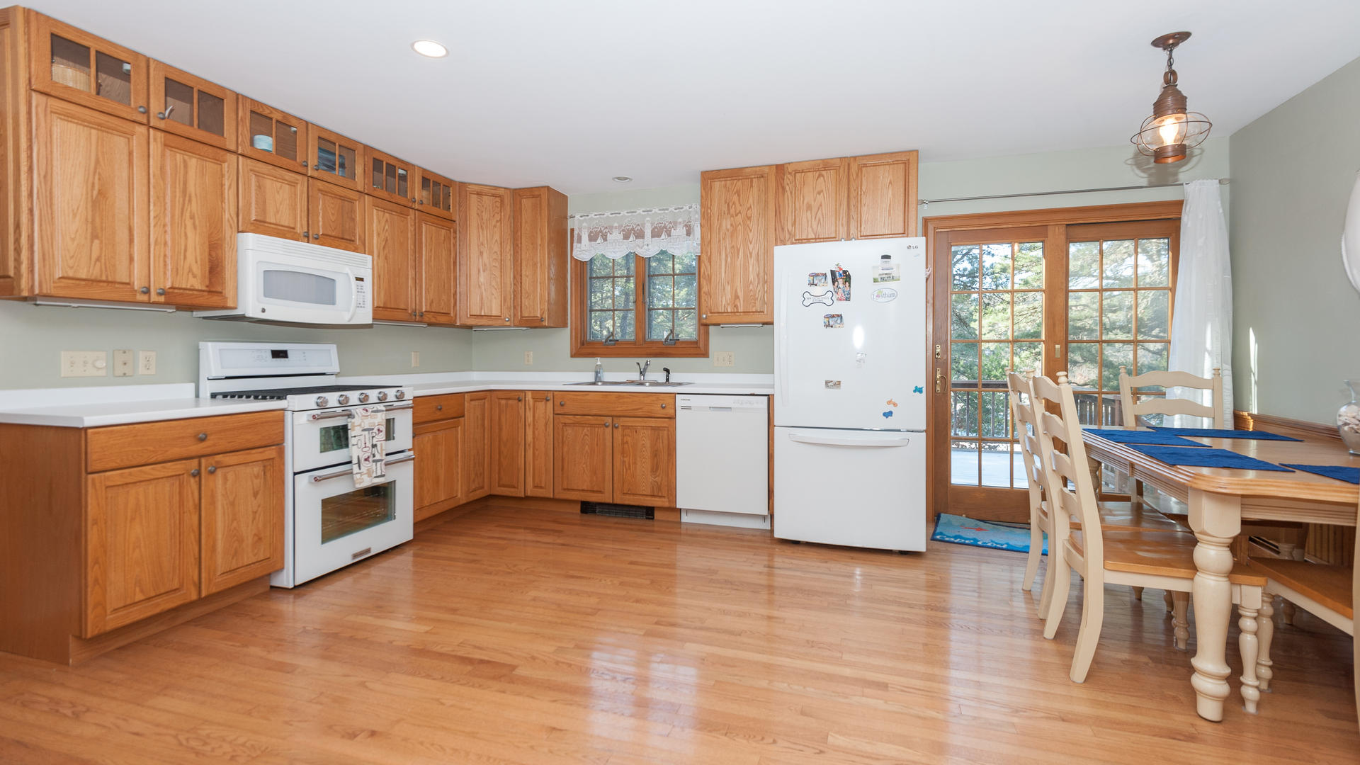 1670 Bridge Road Eastham, MA 02642 - Photo 4 of 12 a kitchen with white cabinets and white appliances