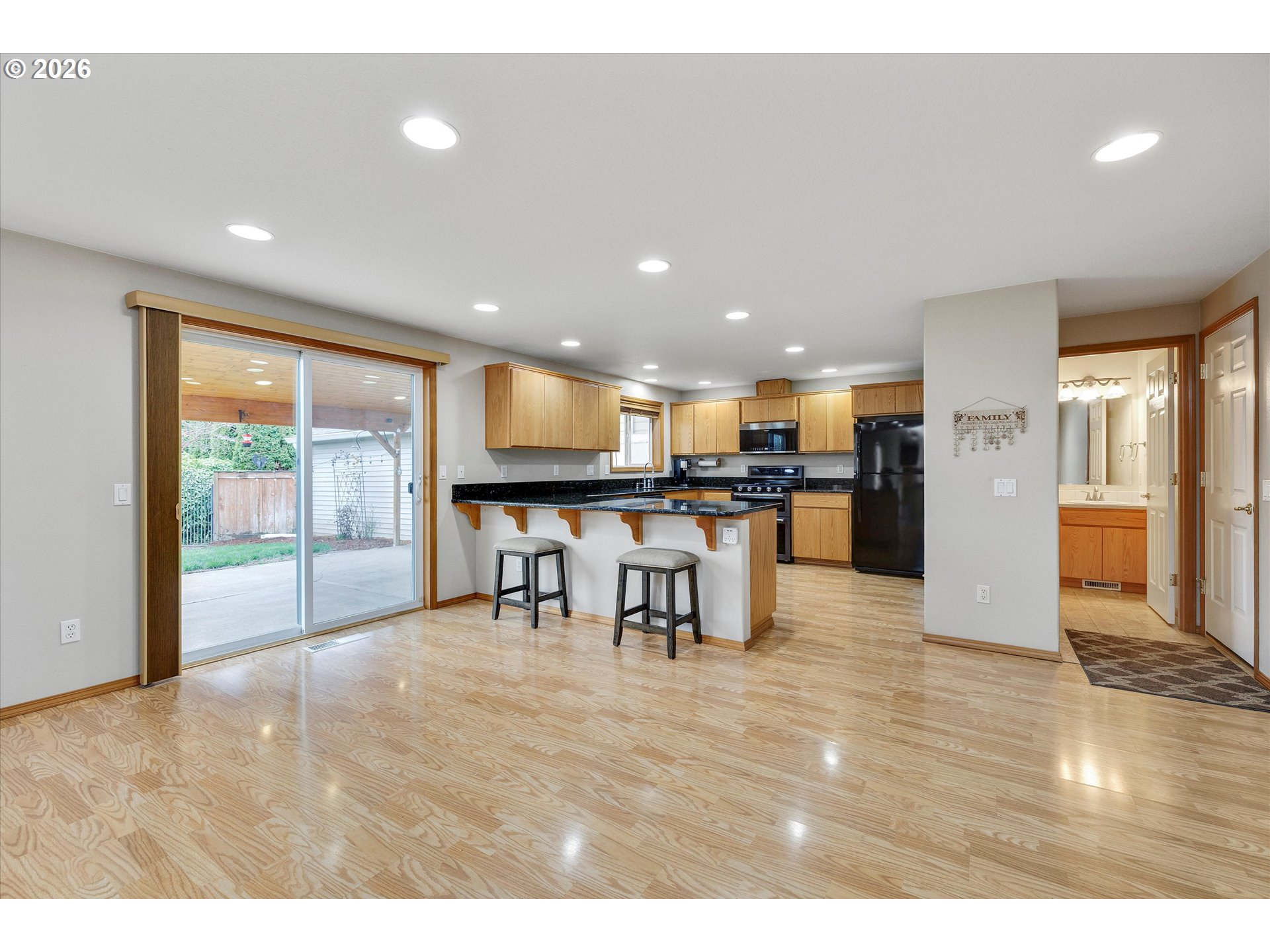 2366 Baines Boulevard Hubbard, OR 97032 - Photo 11 of 48 a view of a kitchen with kitchen island granite countertop a living room