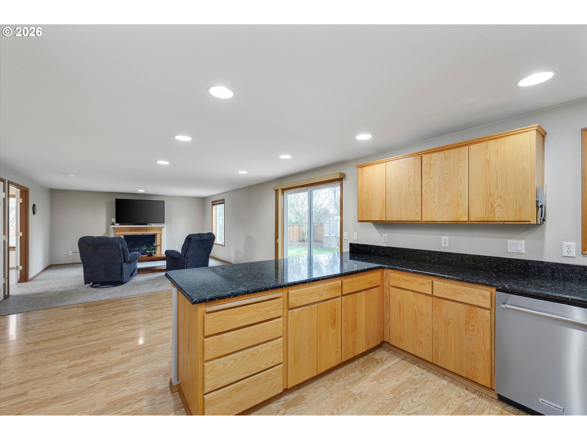 2366 Baines Boulevard Hubbard, OR 97032 - Photo 14 of 48 a kitchen with stainless steel appliances granite countertop a sink a stove and a refrigerator