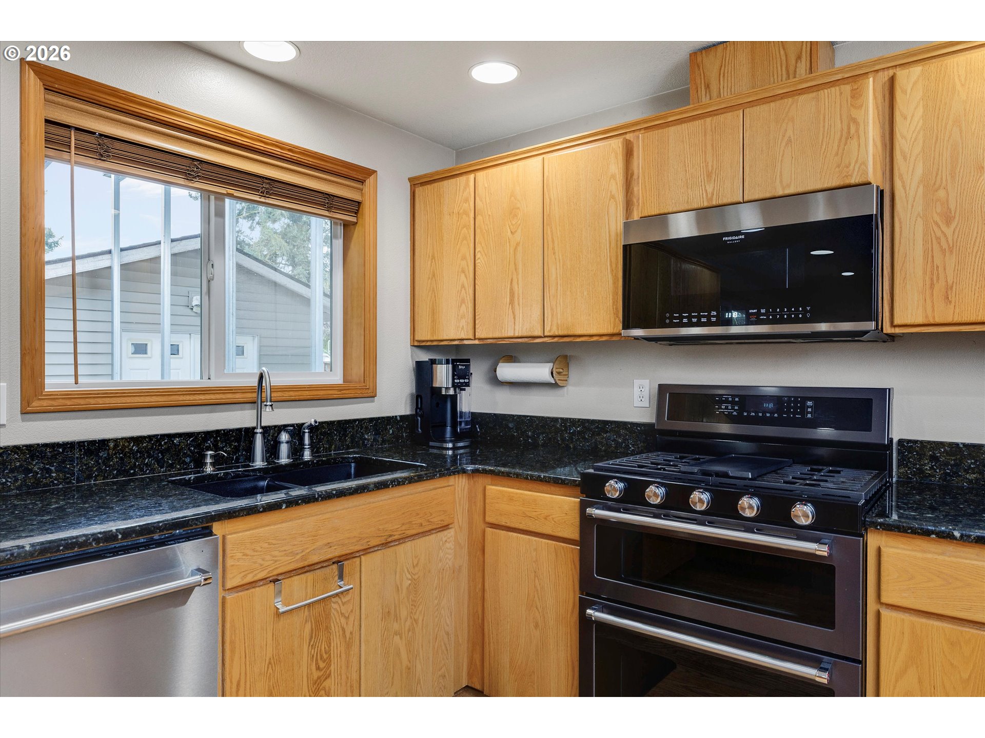 2366 Baines Boulevard Hubbard, OR 97032 - Photo 15 of 48 a kitchen with stainless steel appliances a stove microwave and sink
