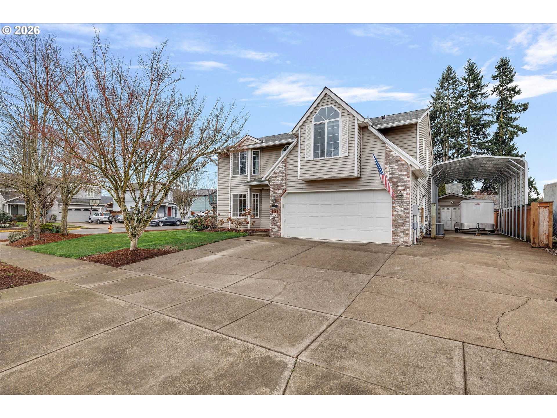 2366 Baines Boulevard Hubbard, OR 97032 - Photo 2 of 48 a front view of a house with a yard and garage