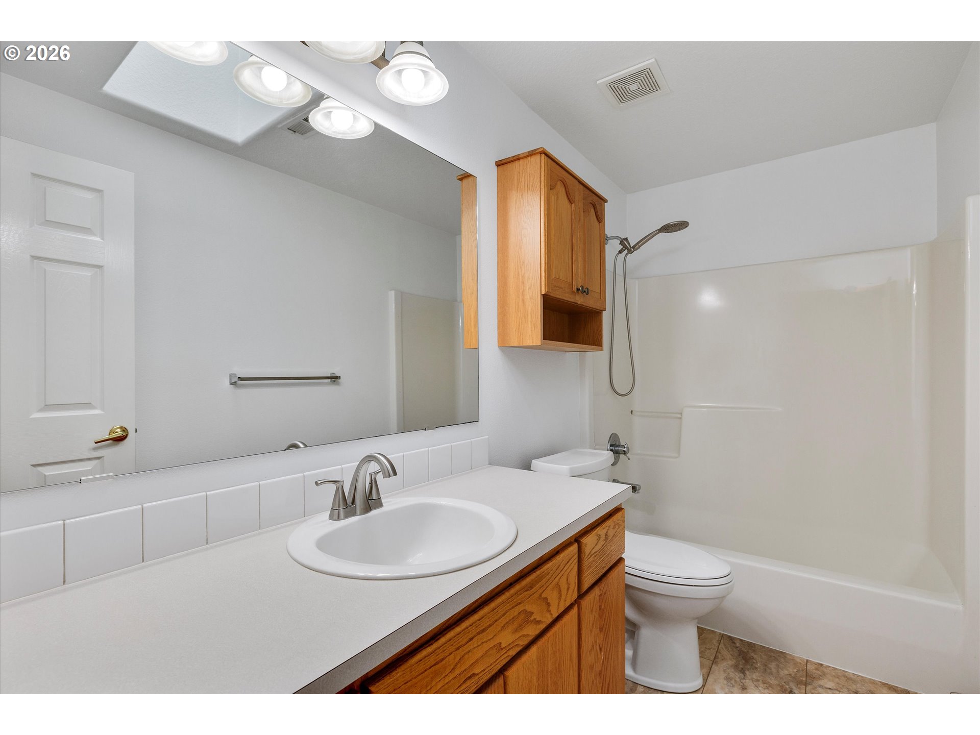 2366 Baines Boulevard Hubbard, OR 97032 - Photo 27 of 48 a bathroom with a sink a toilet and a mirror