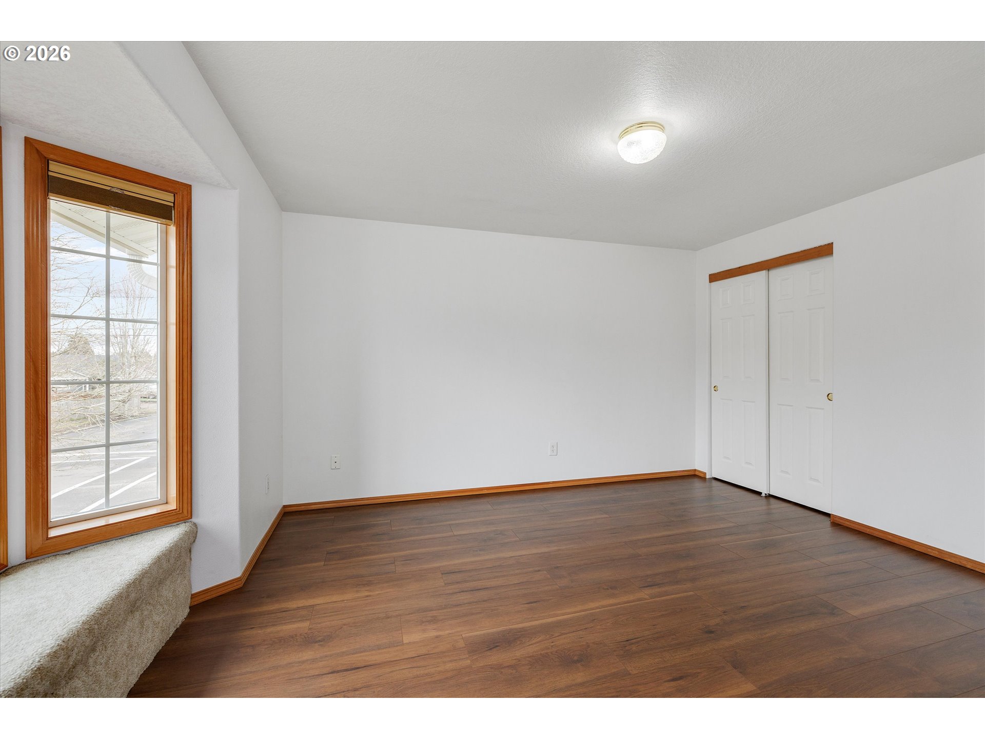 2366 Baines Boulevard Hubbard, OR 97032 - Photo 30 of 48 a view of an empty room with wooden floor and a window