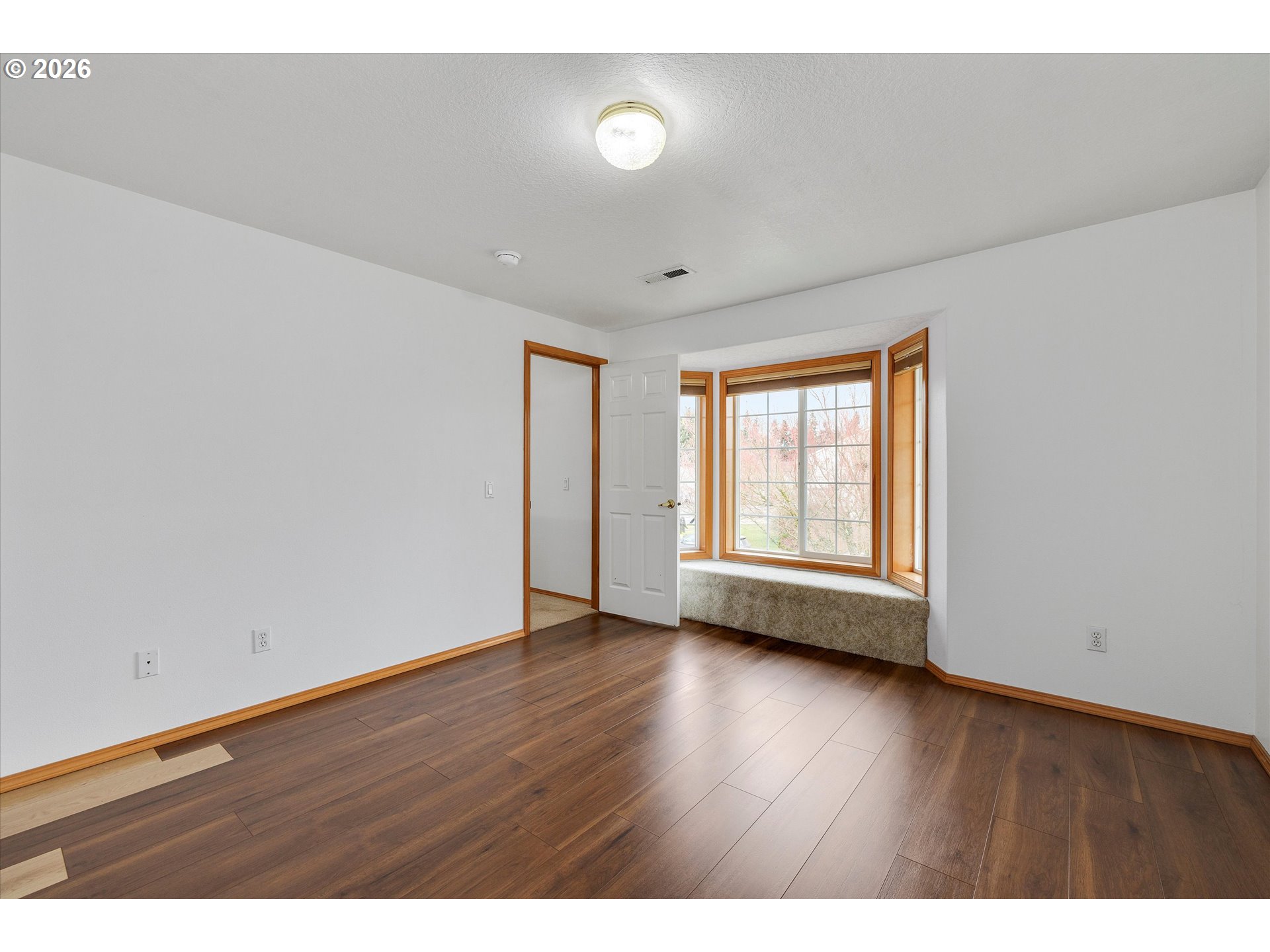 2366 Baines Boulevard Hubbard, OR 97032 - Photo 31 of 48 a view of an empty room with wooden floor and a window