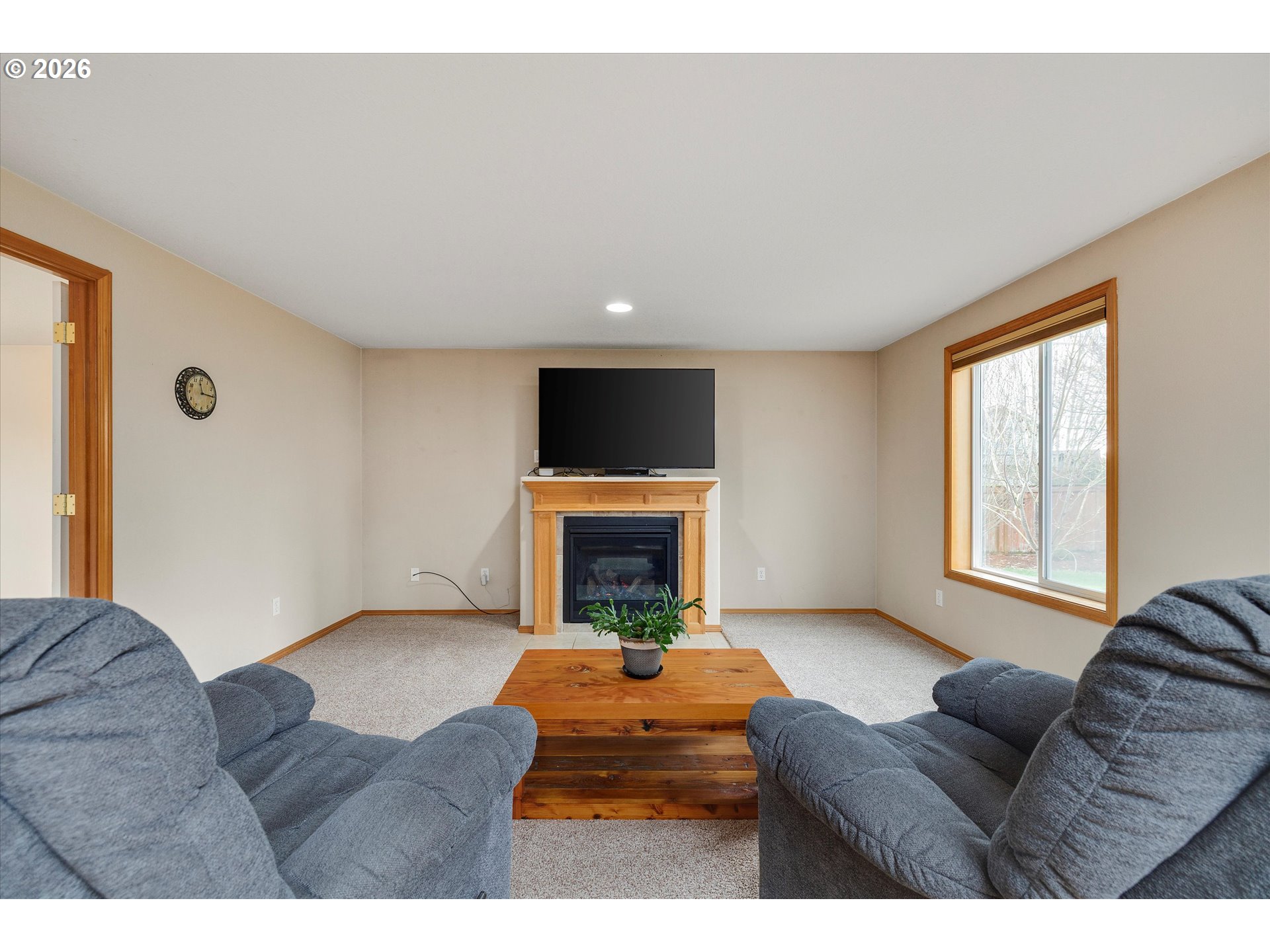 2366 Baines Boulevard Hubbard, OR 97032 - Photo 8 of 48 a living room with furniture a fireplace and a flat screen tv