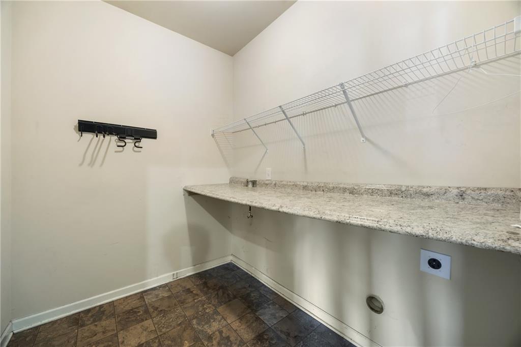6891 Dresden Drive Rex, GA 30273 - Photo 11 of 26 a bathroom with a granite countertop sink and mirror