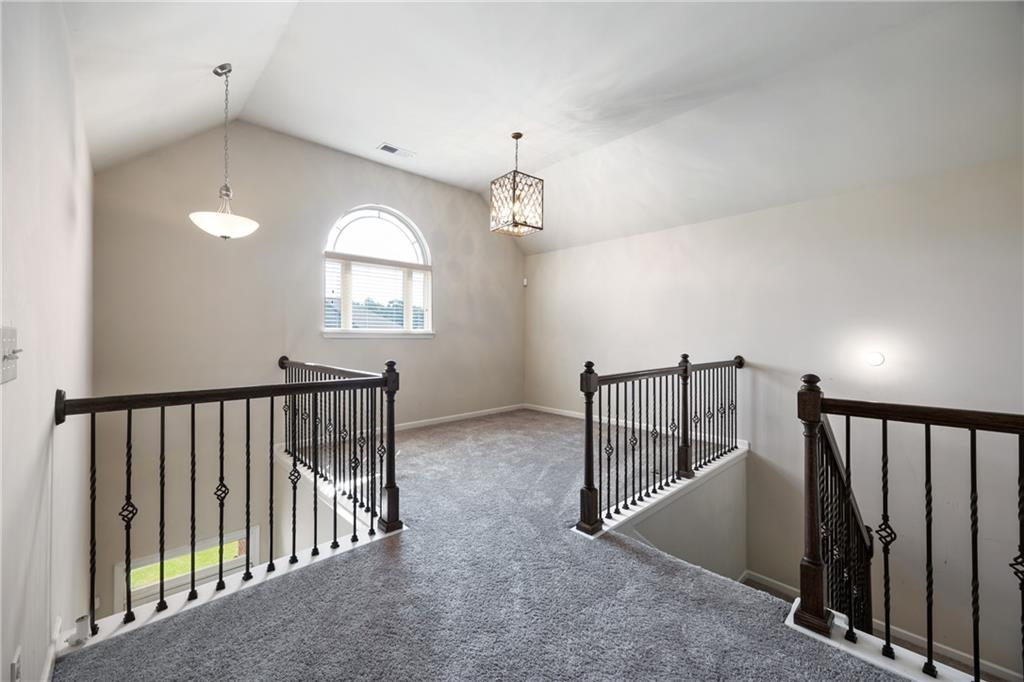 6891 Dresden Drive Rex, GA 30273 - Photo 17 of 26 a view of staircase with railing and a chandelier
