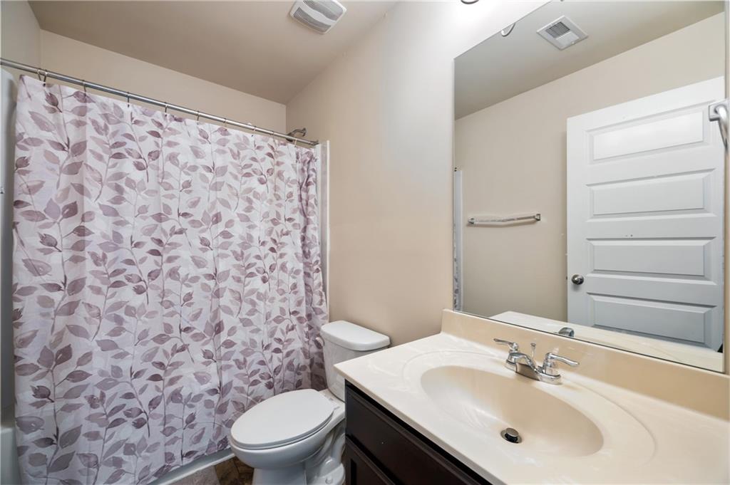 6891 Dresden Drive Rex, GA 30273 - Photo 19 of 26 a bathroom with a sink toilet and a mirror