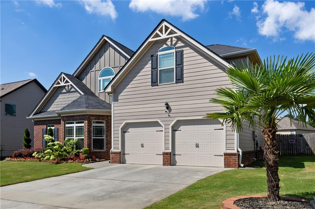 6891 Dresden Drive Rex, GA 30273 - Photo 2 of 26 a front view of a house with a garden and plants