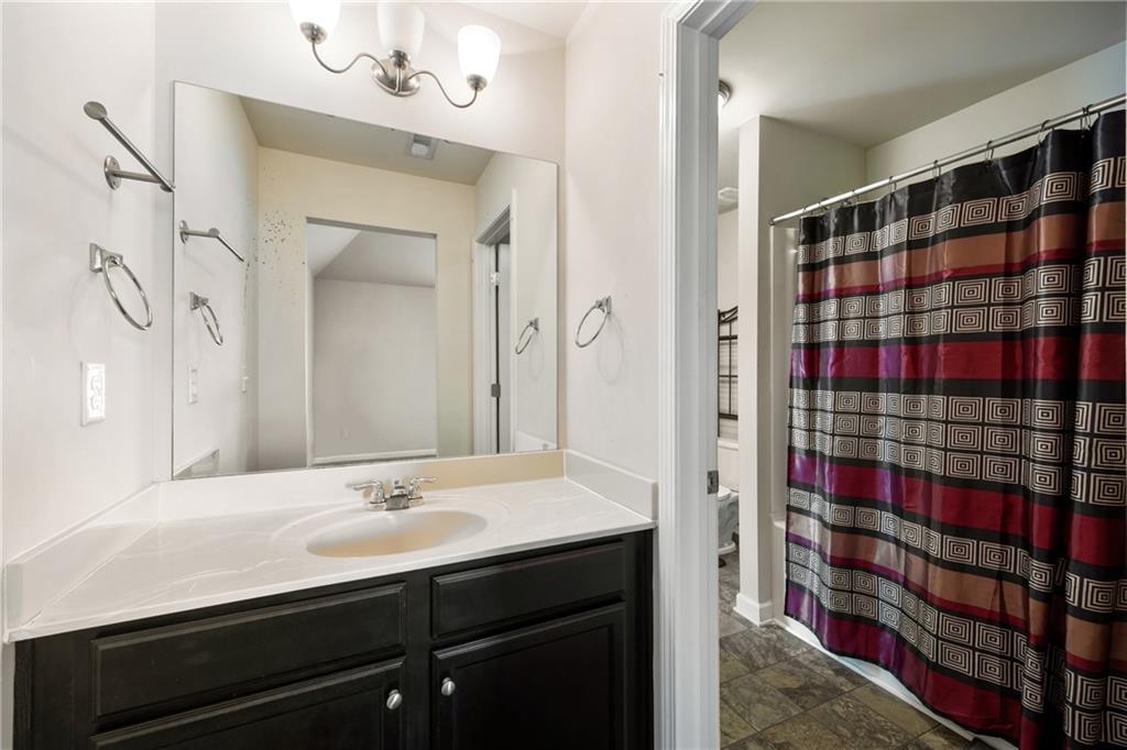 6891 Dresden Drive Rex, GA 30273 - Photo 22 of 26 a bathroom with a sink a vanity and a mirror
