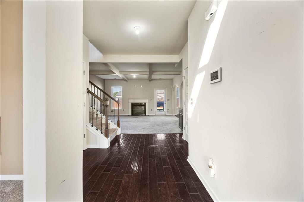 6891 Dresden Drive Rex, GA 30273 - Photo 4 of 26 a view of a hallway with wooden floor and staircase