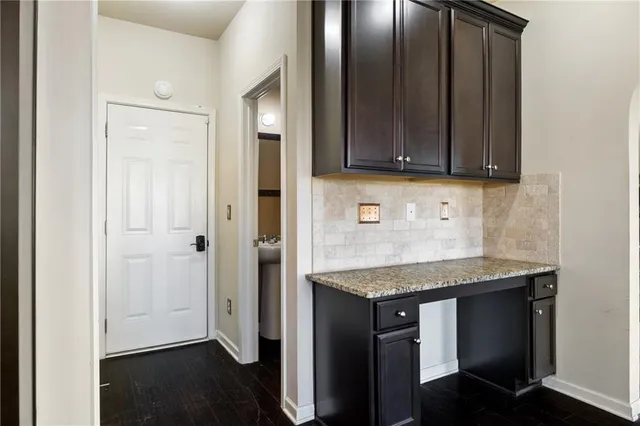 a kitchen with stainless steel appliances granite countertop wooden cabinets a sink and dishwasher