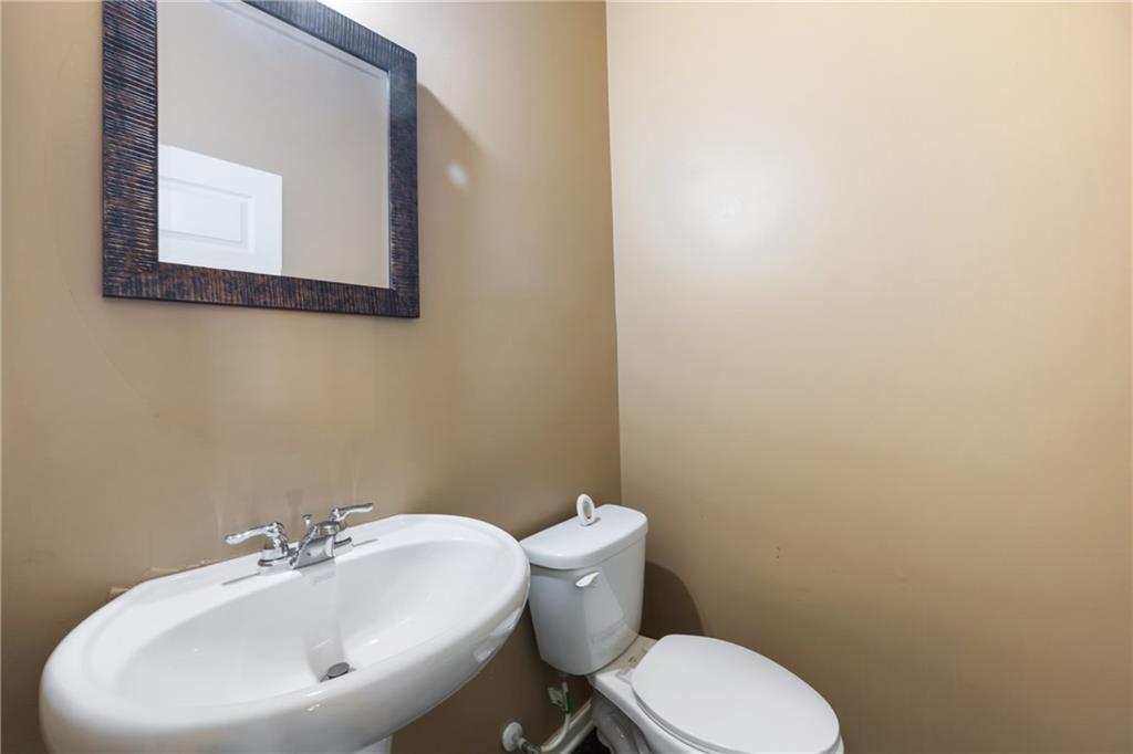 6891 Dresden Drive Rex, GA 30273 - Photo 10 of 26 a bathroom with a toilet sink and mirror