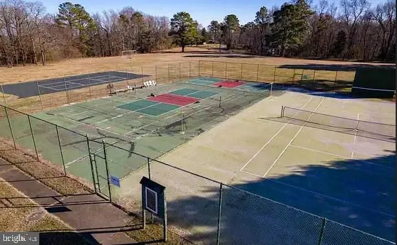 a view of a house with a yard table and chairs