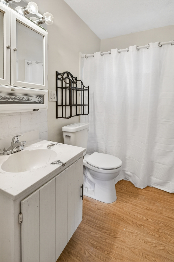 1229 13th Avenue North Clinton, IA 52732 - Photo 17 of 26 a bathroom with a sink toilet and shower
