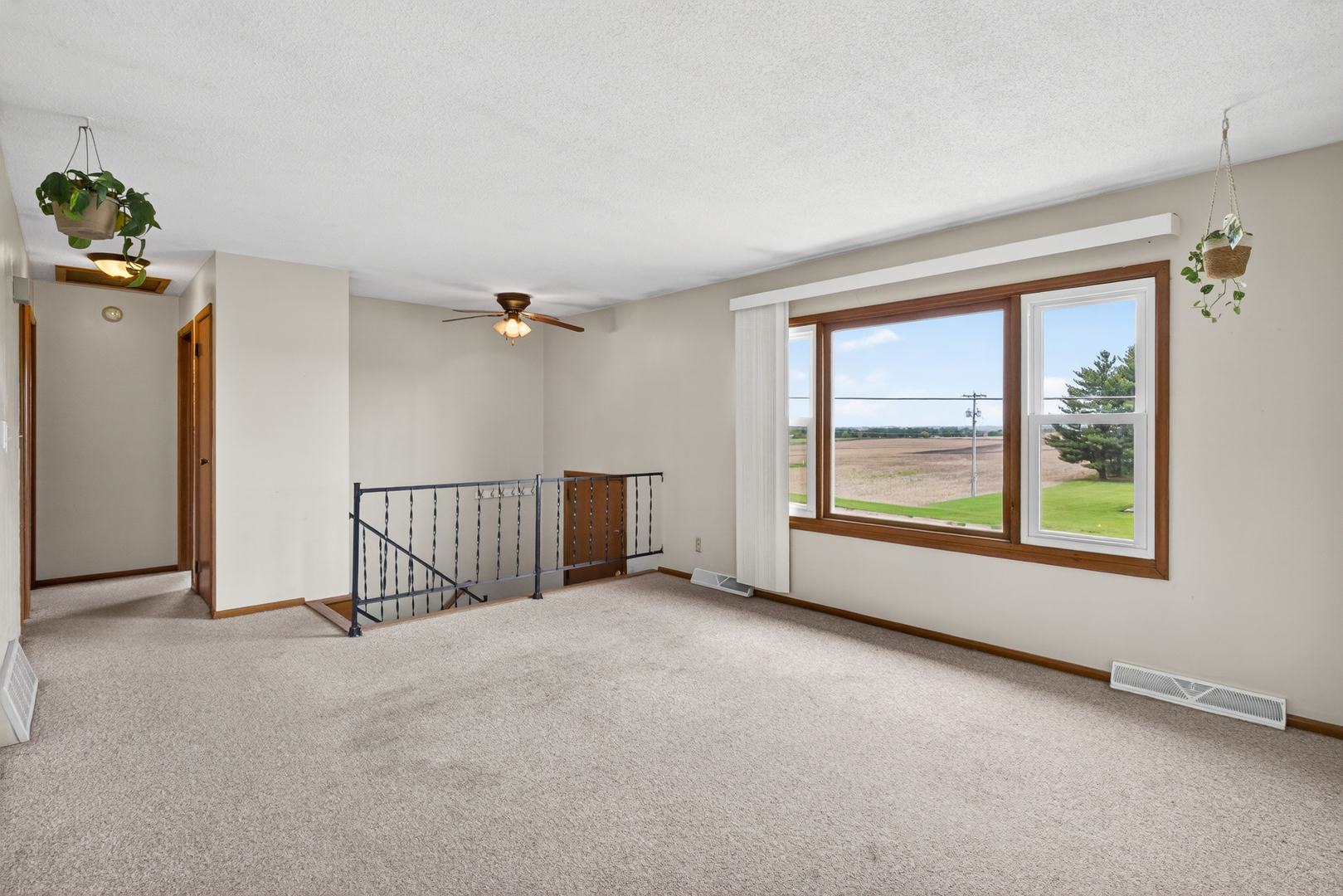 1229 13th Avenue North Clinton, IA 52732 - Photo 8 of 26 an empty room with windows and ceiling fan