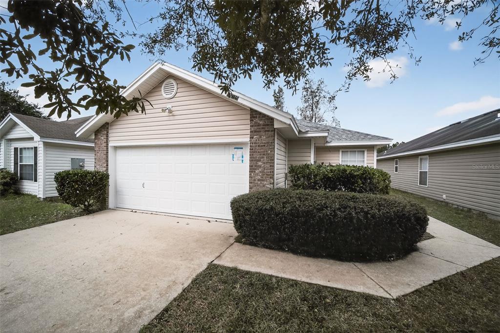 96025 Sunfish Lane Yulee, FL 32097 - Photo 1 of 17 a view of a house with a large tree and a yard