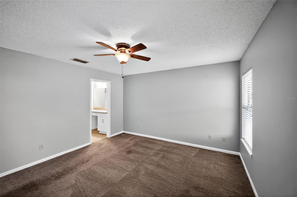 96025 Sunfish Lane Yulee, FL 32097 - Photo 12 of 17 an empty room with a window and a fan